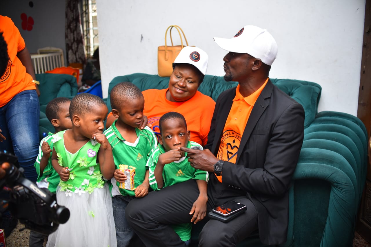 LAOF volunteer sitting with children during a community visit