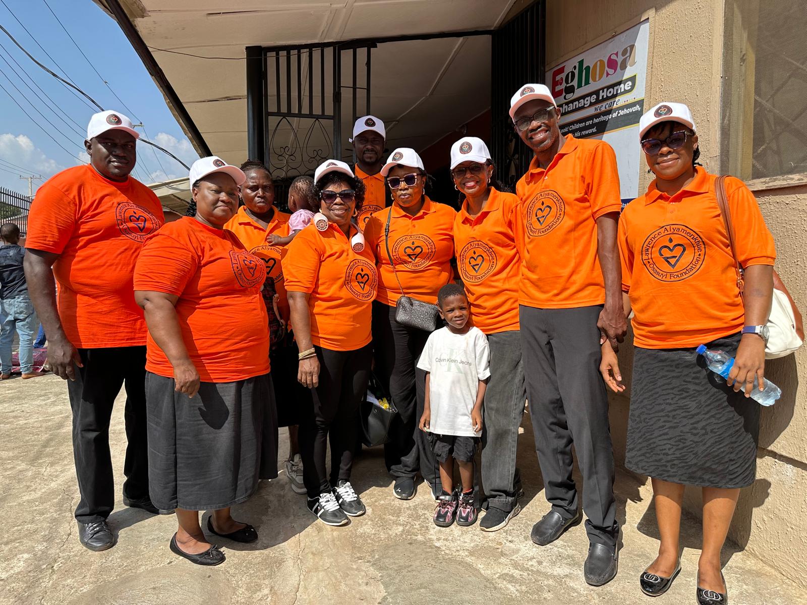 LAOF volunteers in orange shirts gathered outside a community venue