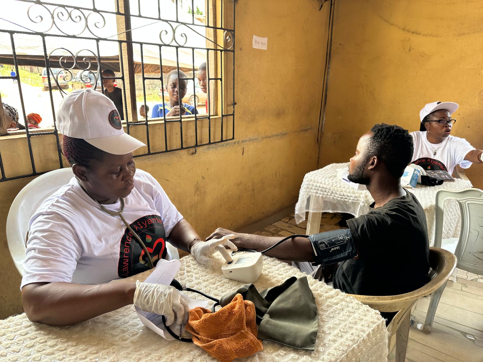 A LAOF health volunteer checking a participant’s blood pressure
