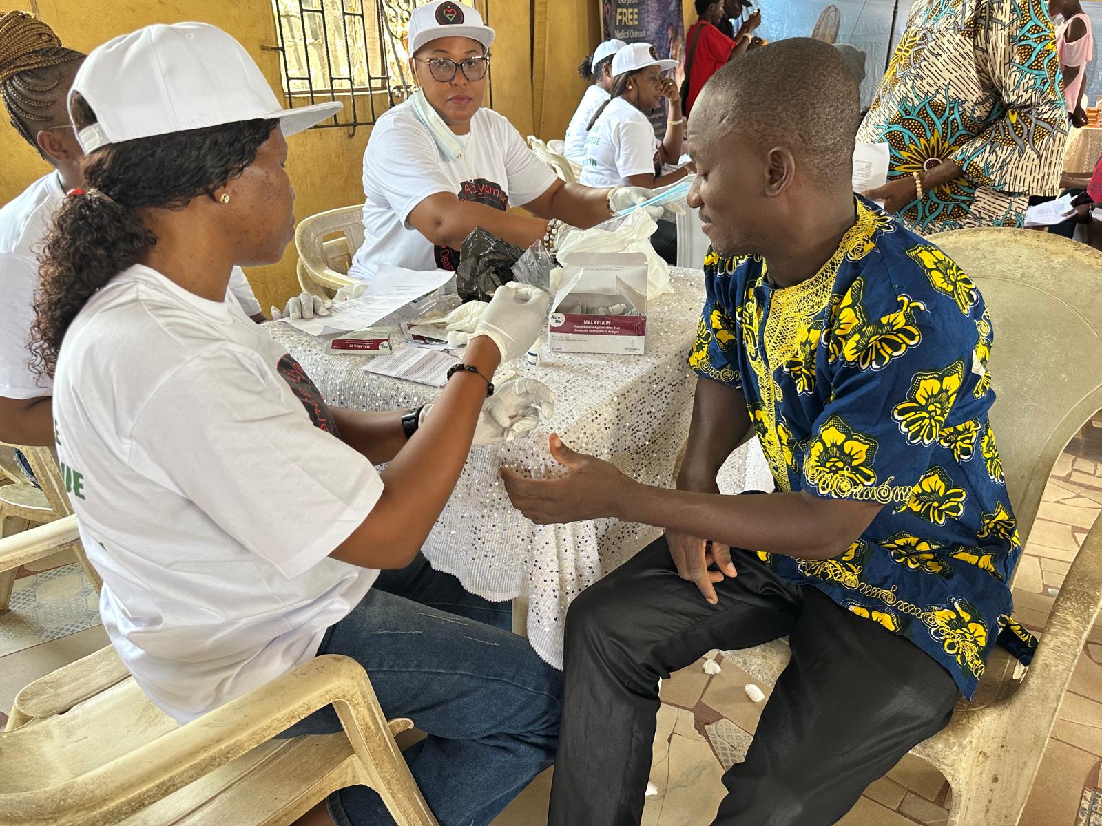A participant receiving a blood pressure check during LAOF health outreach