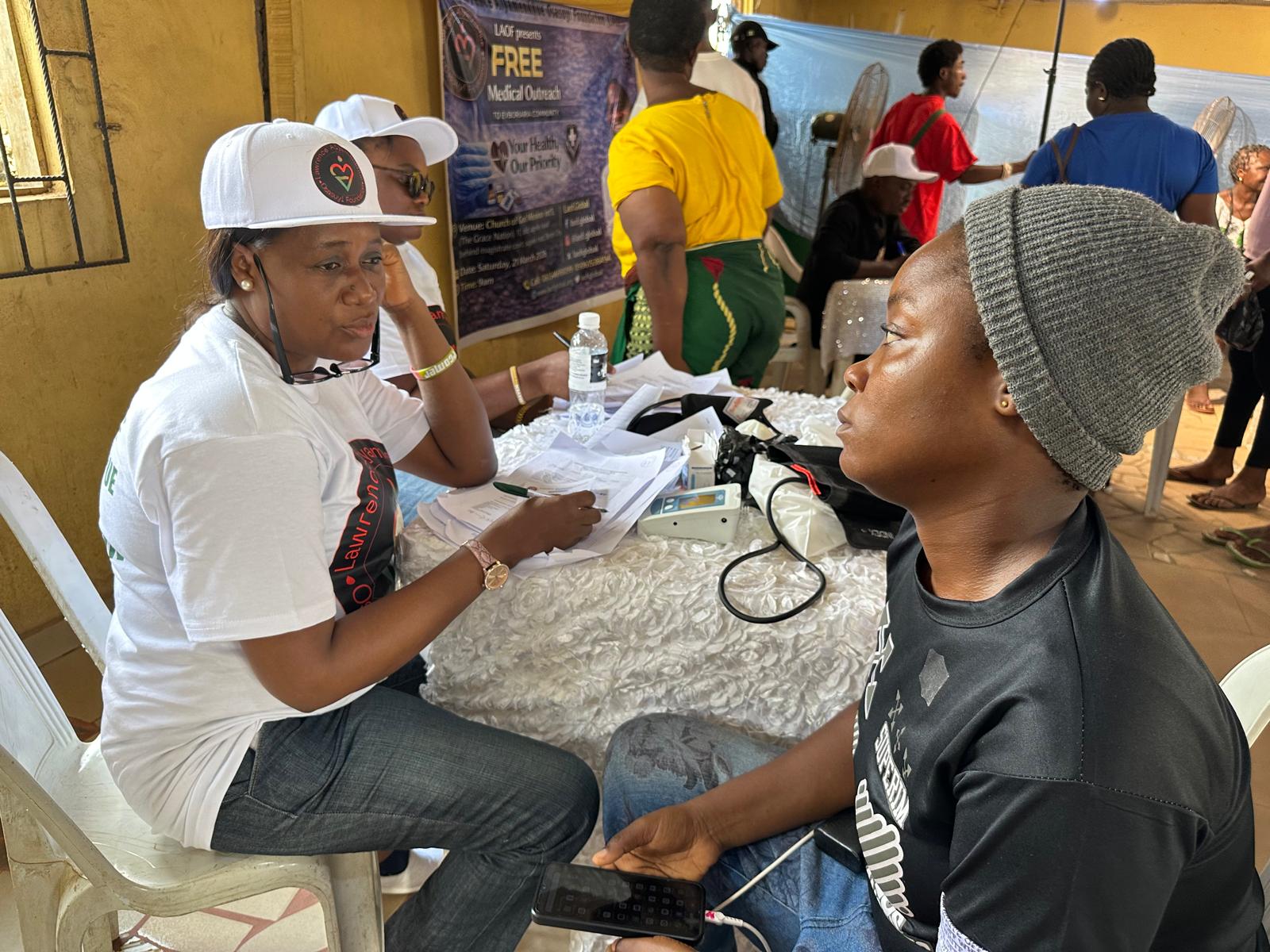 LAOF health volunteer attending to a participant at an outreach clinic