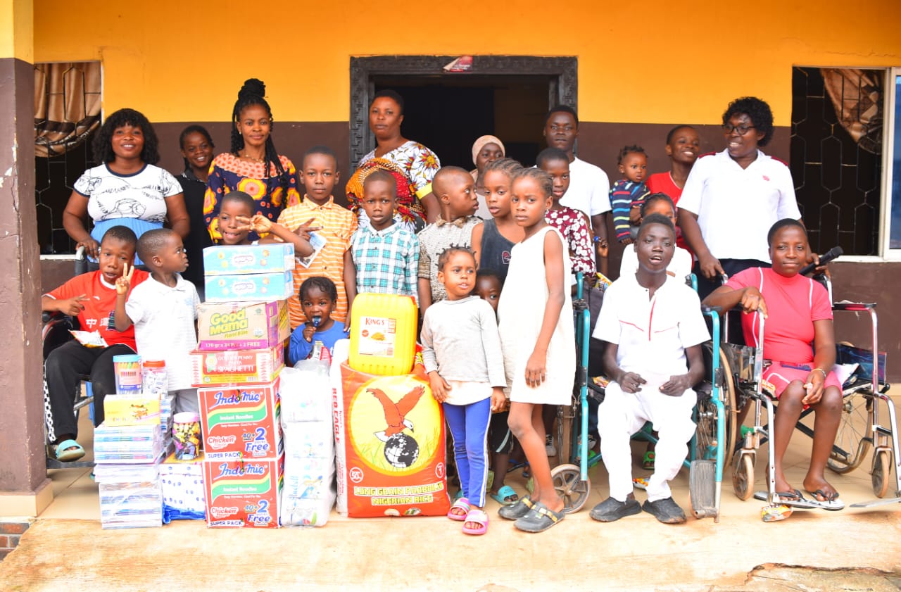 LAOF volunteers and children gathered with donated supplies
