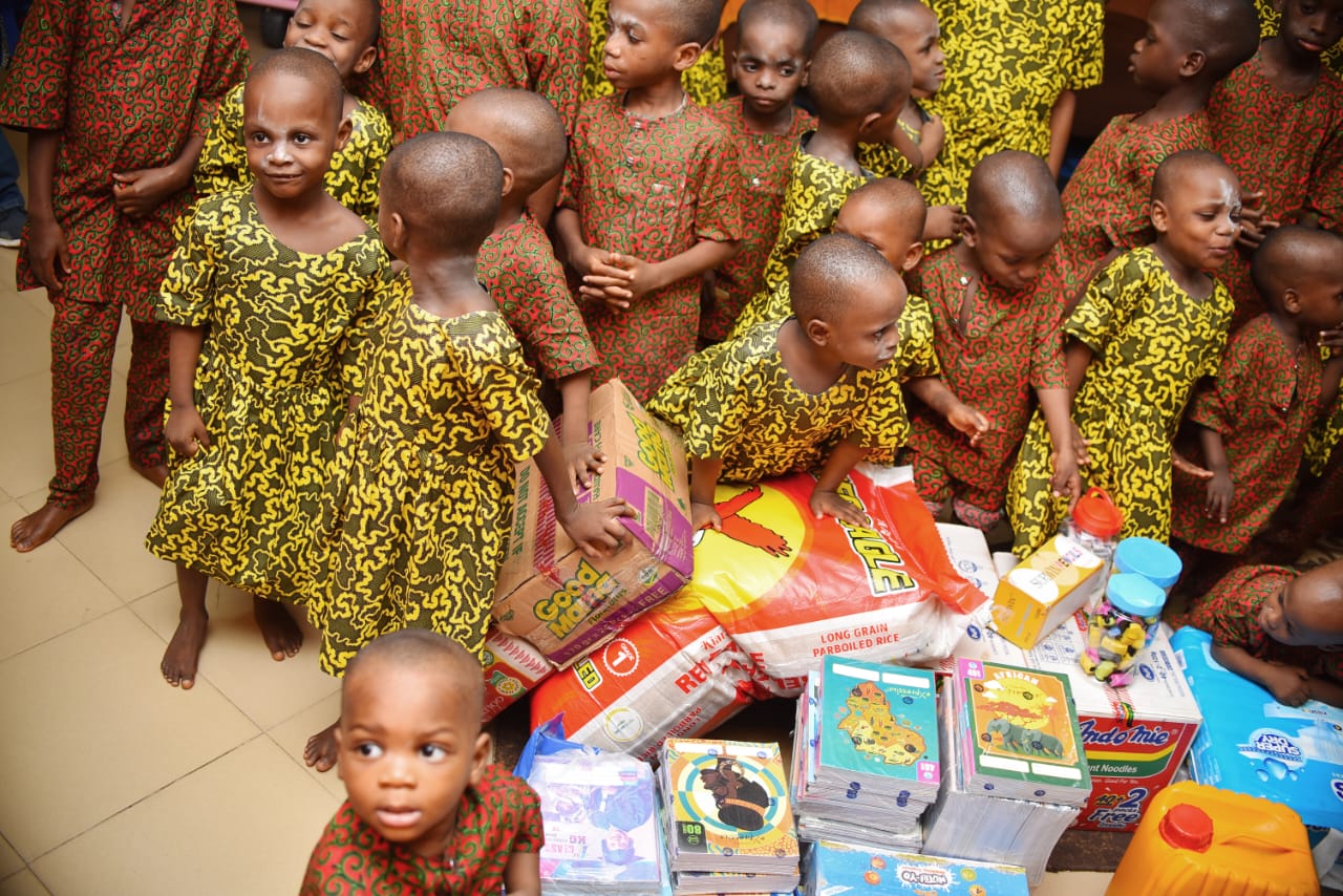Children gathered around donated supplies during a LAOF visit